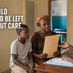 A child and caregiver discussing access to medical care with a healthcare worker in West Africa.